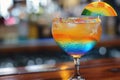 Vibrant Rainbow Layered Cocktail with Ice and Umbrella Decoration