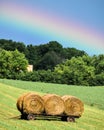 Vibrant Rainbow over Three Rolled Haystacks Royalty Free Stock Photo
