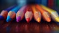 Vibrant rainbow pencils resting on wooden surface, inspiring creativity and imagination Royalty Free Stock Photo