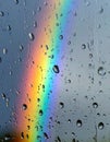 Vibrant Rainbow Refracted Through Raindrops on Glass Window Overcast Weather Pattern Royalty Free Stock Photo
