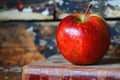 A vibrant red apple rests gracefully atop an open book, creating a harmonious blend of nature and knowledge Royalty Free Stock Photo