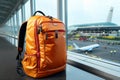 Vibrant red backpack accompanies a traveler in the bustling airport