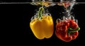 Red and Yellow Bell Peppers Splashing into Water, Black Background, Freshness Royalty Free Stock Photo