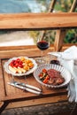 Vibrant red chili peppers and assorted spices in a wooden bowl, a fresh and healthy addition to your kitchen ingredients, Royalty Free Stock Photo