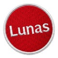 A vibrant red circular patch with the word \'lunas\' in white cursive font. isolated on white background Royalty Free Stock Photo