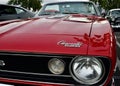 a red Classic vintage Chevrolet Convertible car at a classic car show with back trunk open