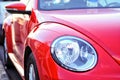 Vibrant red colour car side view and detailed car light. Modern Royalty Free Stock Photo