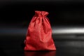 Vibrant red drawstring bag on black background showcasing texture and design Royalty Free Stock Photo