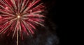 Vibrant red and gold fireworks exploding in the night sky Royalty Free Stock Photo