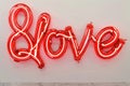 A vibrant red neon sign that reads \