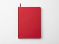 Vibrant red notebook standing against a plain white background Royalty Free Stock Photo