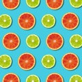 Vibrant red orange and green lime lemon slices pattern on turquoise background Royalty Free Stock Photo