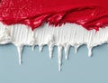 Vibrant red paint dripping over white surface Royalty Free Stock Photo