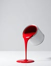 Vibrant Red Paint Pouring from a Can on White Royalty Free Stock Photo
