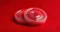 Vibrant red plastic rings on a red background Royalty Free Stock Photo