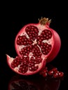 Vibrant red pomegranate cut open revealing juicy arils against a dark background fruit Royalty Free Stock Photo