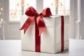 Vibrant Red Ribbon Bow on White Gift Box - Striking Contrast for Eye-Catching Appeal