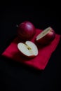 Vibrant red Royal Gala English apples on red tea towel