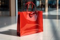 Vibrant red shopping bags placed neatly on the boutiques floor