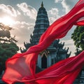 Red Silk Scarf Billowing in Front of a Temple Pagoda at Sunset fabric flowing Royalty Free Stock Photo