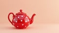 Vibrant red teapot with white polka dots on a solid background