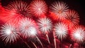 Vibrant red and white fireworks exploding in a dark night sky explosion celebration Royalty Free Stock Photo