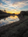 Vibrant reflection of the sun and blue sky in the river Dyle in Mechelen Royalty Free Stock Photo