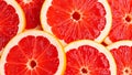 This vibrant and refreshing close-up image features a beautiful arrangement of freshly sliced ruby red grapefruit, creating a stri Royalty Free Stock Photo