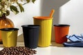 Vibrant reusable cups and spilled coffee beans in sunlit kitchen scene Royalty Free Stock Photo