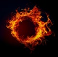 A vibrant ring of fire with swirling flames against a black background. A glowing flame circle in red, orange, yellow Royalty Free Stock Photo