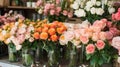 Vibrant rose bouquets in shades of peach, pink, and white arranged in a florist\'s shop