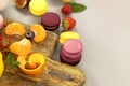 Vibrant scene of table filled with macaroons and fruits