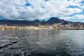 Vibrant scenery and deep-blue waters of the Tenerife west coastline as seen from a yacht. The dormant Teide volcano can be seen in