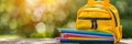 Vibrant school backpack with supplies on table, blurred backgroundback to school theme Royalty Free Stock Photo