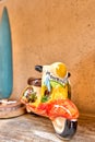 Vibrant scooter figurine sitting on a wooden table, providing a colorful and unique contrast