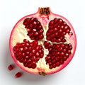Translucent pomegranate section exhibiting ruby arils detail and structure on white background Royalty Free Stock Photo