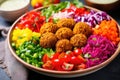 a vibrant shot of a falafel salad with rainbow-colored toppings