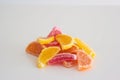 Vibrant sliced candied citrus fruits macro close up shot. Isolated on white, no people Royalty Free Stock Photo