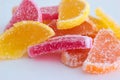 Vibrant sliced candied citrus fruits macro close up shot. Isolated on white, no people Royalty Free Stock Photo