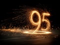 Vibrant sparkler pattern forms number 95 on dark background, dynamic lighting, fleeting moment of light against darkness Royalty Free Stock Photo