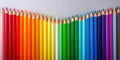 Vibrant spectrum of colored pencils arranged in a smooth gradient displaying a full range of hues. Generative AI Royalty Free Stock Photo