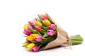 Vibrant spring tulip bouquet in pink, red and yellow with eco-friendly packaging on white background Royalty Free Stock Photo