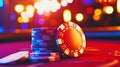 A vibrant stack of poker chips on the table surrounded by bright casino lights at night Royalty Free Stock Photo