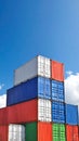 Vibrant stacked shipping cargo containers under a clear blue sky symbolizing global logistics Royalty Free Stock Photo
