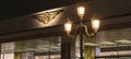 a storefront lit up at night with illuminated light fixture