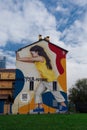 Milan, Italy Colorful wall graffiti under blue sky.