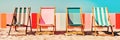 Vibrant striped beach chairs near multicolored colorful wall and blue sky. Bright summer vacation relax background. Created with