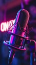 Vibrant studio microphone in focus with neon ON AIR sign glowing in the background Royalty Free Stock Photo