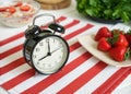 Bright Alarm Clock on Striped Background A Versatile Prop for Food Photography Time Management and Productivity Royalty Free Stock Photo