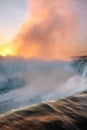 Vibrant sunrise illuminating the mist over Niagara Falls